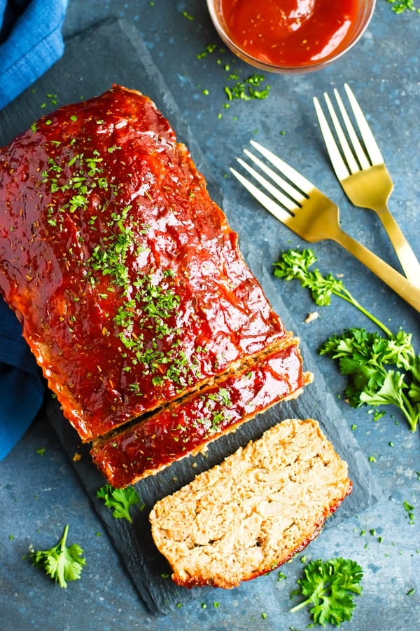 Paleo turkey meatloaf recipe on a slab with garnish.