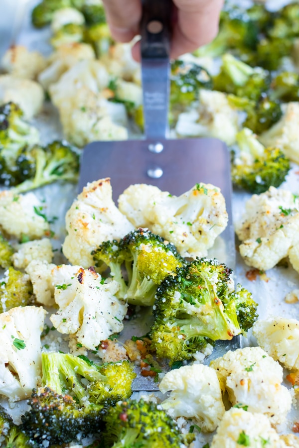 Roasted broccoli cauliflower is full of garlic, parmesan, and lemon zest for a flavorful and healthy baked side.