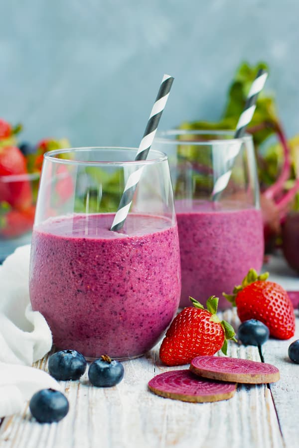 Gluten-free beet smoothie recipe in two glasses with straws.
