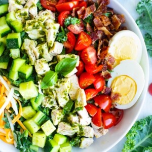 Overhead picture of a healthy Cobb salad in a white bowl.