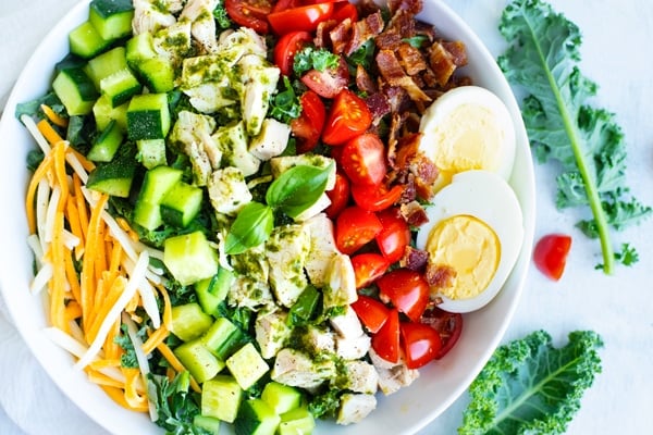 Overhead picture of a healthy Cobb salad in a white bowl.