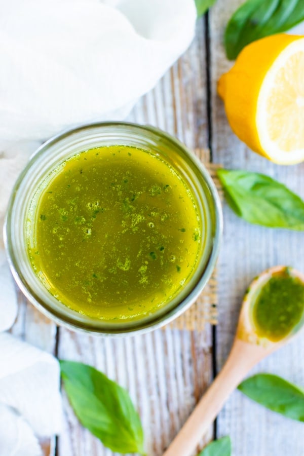 Easy vinaigrette dressing with basil and lemon in a glass jar.