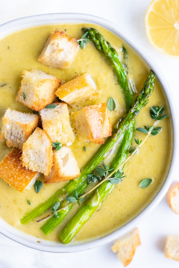 Gluten-free and dairy-free vegan cream of asparagus soup that is made with coconut milk and no heavy cream for a Spring lunch idea.
