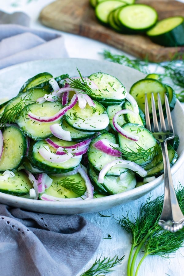 Easy Cucumber Dill Salad recipe in a bowl with a fork.