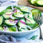 Delicious cucumber dill salad in a bowl with a fork on the side.