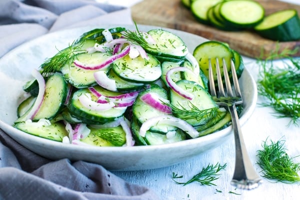 Delicious cucumber dill salad in a bowl with a fork on the side.