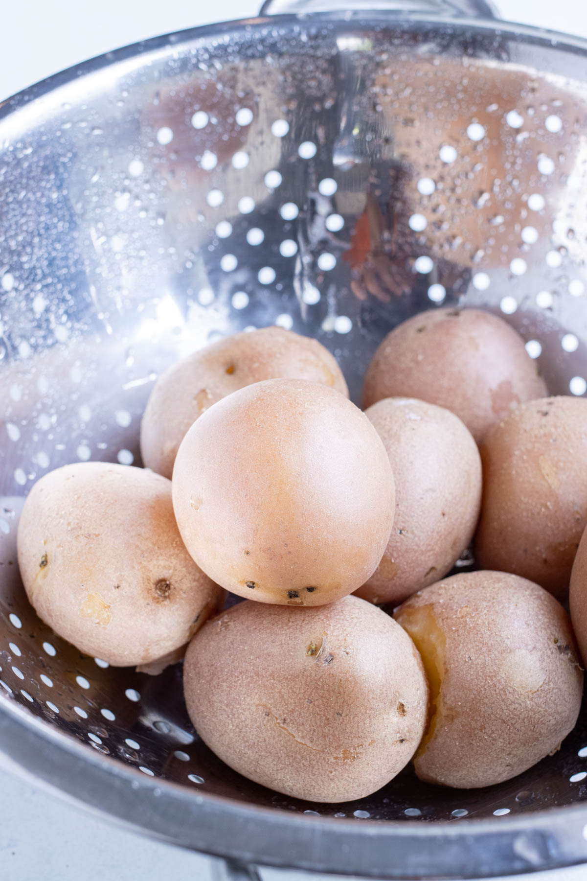 Potatoes are drained in a colander.