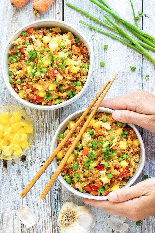 An overhead picture of two bowls of Pineapple Cauliflower Fried Rice for lunch.
