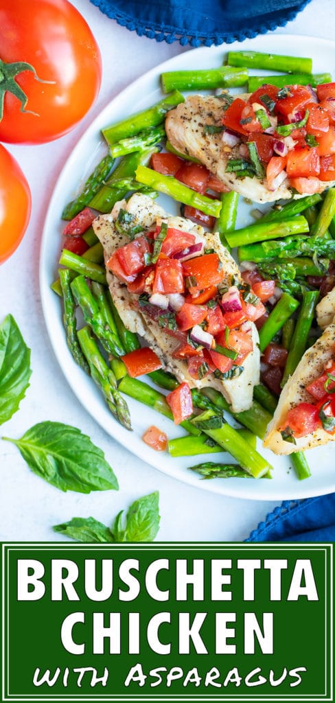A dinner plate serving Whole30 asparagus with seared chicken and a tomato basil bruschetta.