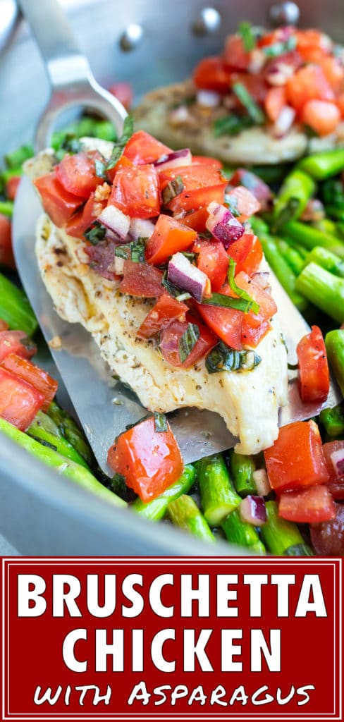 A spatula picking up a chicken breast topped with tomato bruschetta.