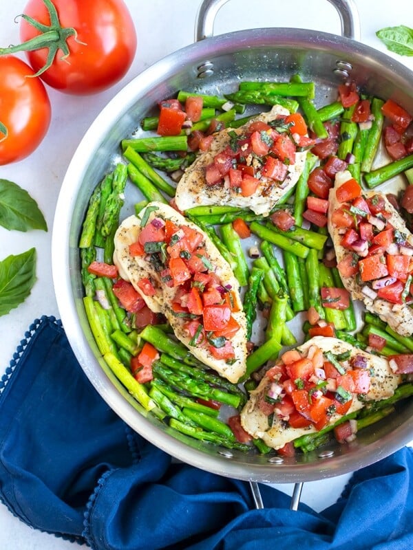 A 30-minute bruschetta chicken recipe made with basil, tomatoes, and asparagus in under 30 minutes.