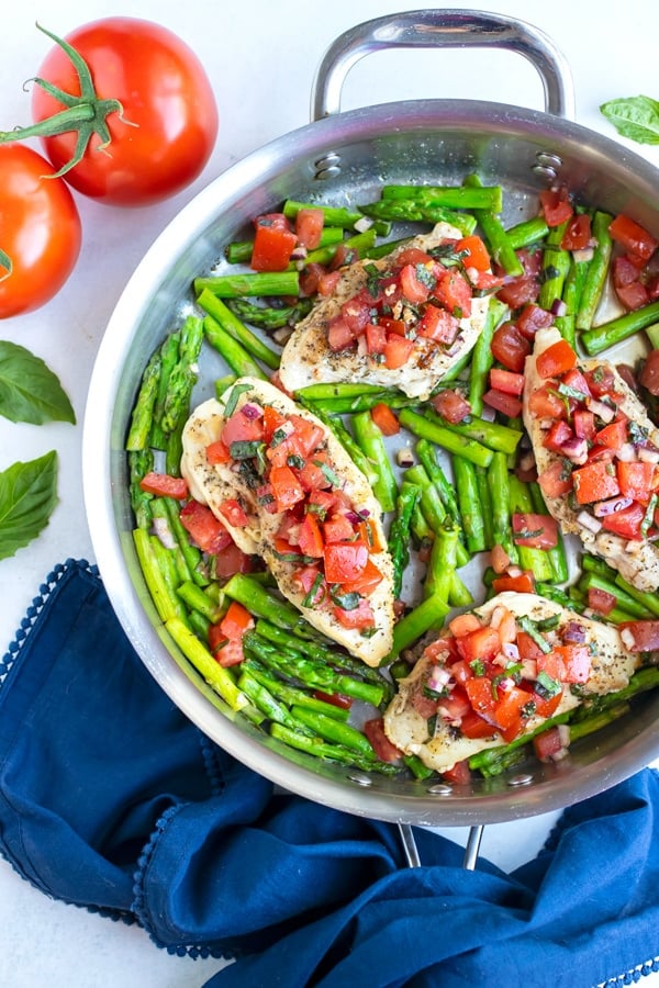 A 30-minute bruschetta chicken recipe made with basil, tomatoes, and asparagus in under 30 minutes.