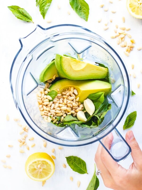 Ingredients for Vegan Avocado Pesto Recipe in a blender.