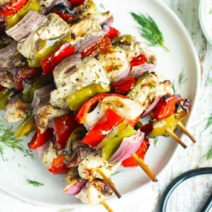 Easy Grilled Greek Chicken Shish Kabobs on a white plate for dinner.