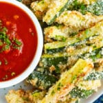 Crispy on the outside and soft on the inside, these Baked Parmesan Zucchini Fries are the perfect way to sneak in your vegetables at dinner! Baked zucchini fries are quick, easy, gluten-free, and a healthy alternative to normal french fries!
