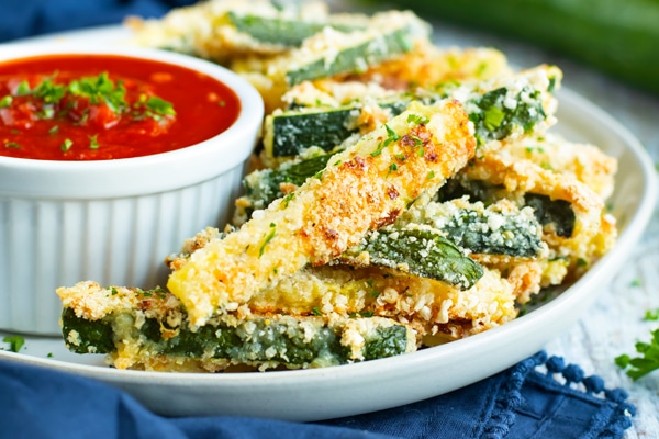 Picture of baked zucchini fries recipe with sauce on the side.
