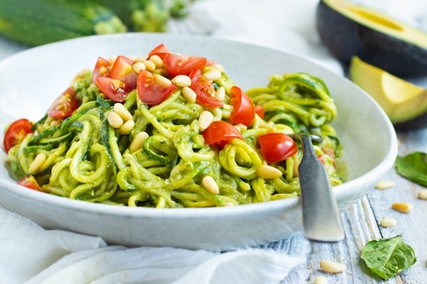 Easy Zucchini Noodles with Pesto recipe in a bowl with a napkin.