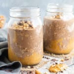 Two glass jars of vegan overnight oats recipe with a gray napkin.