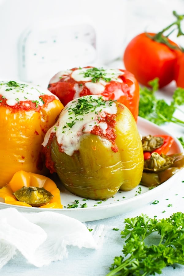 Crock Pot Stuffed Peppers are loaded with lean ground turkey, cooked rice, and then topped with a flavorful tomato sauce for an easy and healthy weeknight dinner recipe.  Making this gluten-free stuffed bell peppers recipe in the slow cooker also makes clean-up a breeze!