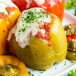 Crock Pot stuffed peppers are loaded with lean ground turkey, cooked rice, and then topped with a flavorful tomato sauce for an easy and healthy weeknight dinner recipe.  Making this gluten-free stuffed bell peppers recipe in the slow cooker also makes clean-up a breeze!
