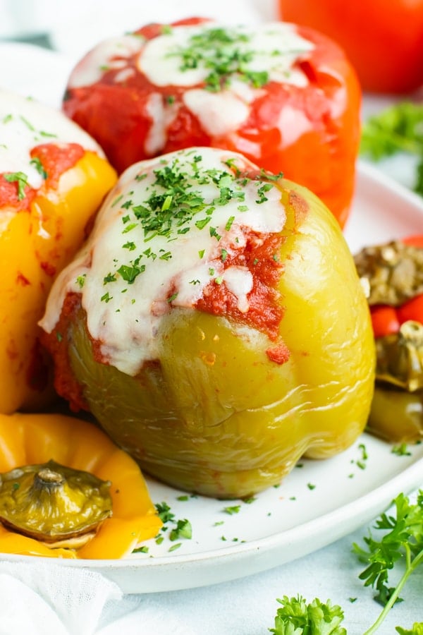 Crock Pot stuffed peppers are loaded with lean ground turkey, cooked rice, and then topped with a flavorful tomato sauce for an easy and healthy weeknight dinner recipe.  Making this gluten-free stuffed bell peppers recipe in the slow cooker also makes clean-up a breeze!