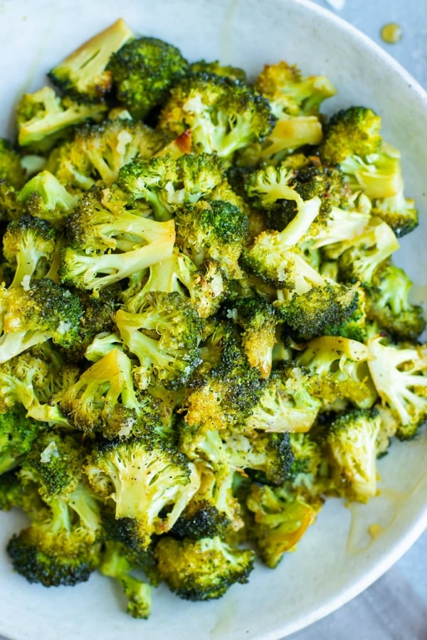Overhead picture of honey oven roasted broccoli in a white bowl.