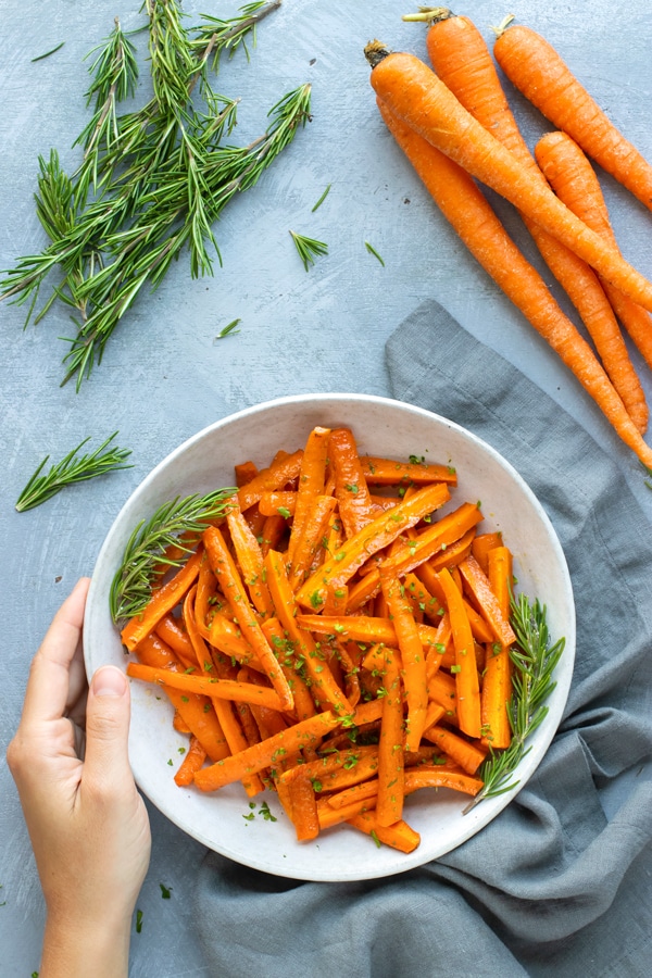 Honey Roasted Carrots Recipe | Honey roasted carrots are tossed in a sweet honey and herb sauce for a quick and easy side dish recipe.  This healthy, easy, gluten-free, low-carb, dairy-free, and vegetarian roasted carrots recipe is ready and on the table in under 30 minutes.  This honey roasted carrots recipe teaches you how to roast carrots in the oven.