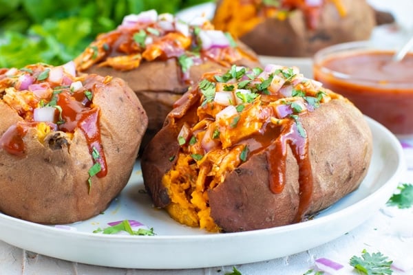 BBQ Chicken Stuffed Sweet Potatoes RECIPE served on a white plate.