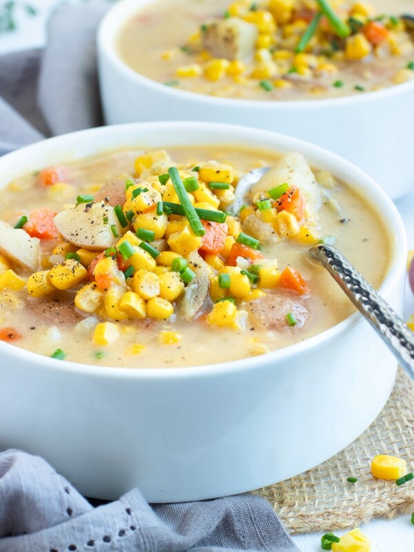 Picture of two white bowls filled with Instant Pot Potato Corn Chowder.