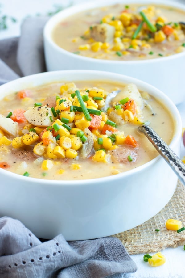 Picture of two white bowls filled with Instant Pot Potato Corn Chowder.