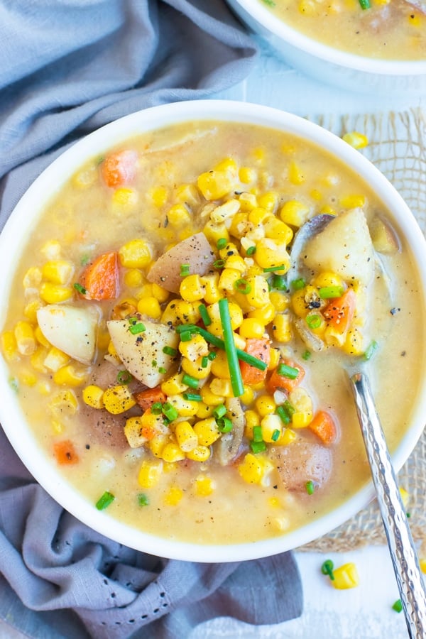 Gluten-free corn chowder recipe in a white bowl.