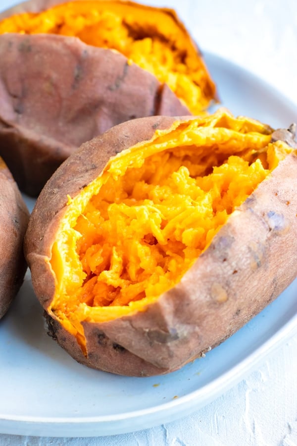 Mashed Instant Pot sweet potato on a white plate.