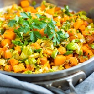 Skillet Brussel sprouts and sweet potatoes caramelized in one pan for an easy weeknight side dish.
