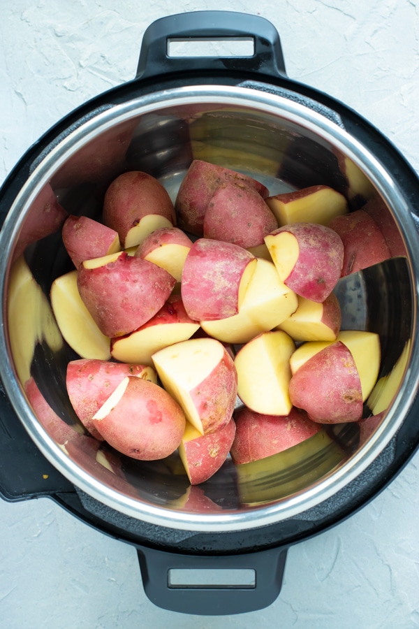 Quartered red skin potatoes in an Instant Pot to make mashed potatoes.
