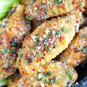 Garlic parmesan chicken wings with a sprinkle of parsley for a Super Bowl party appetizer.