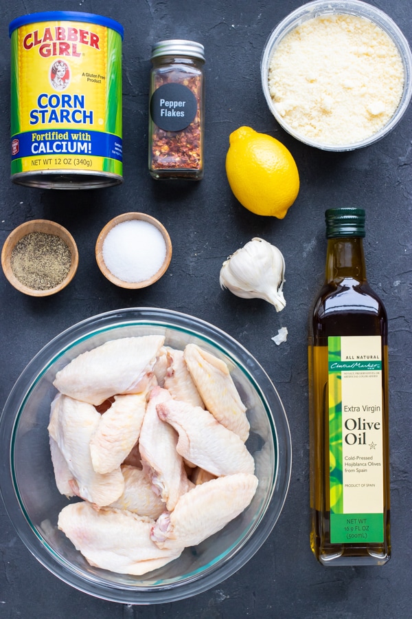 Garlic, parmesan, oil, lemon juice, and cornstarch as the ingredients for a baked chicken wings recipe.