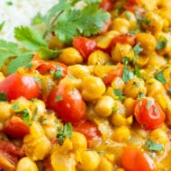 A close-up of vegetarian chickpea curry and tomatoes with basmati rice.