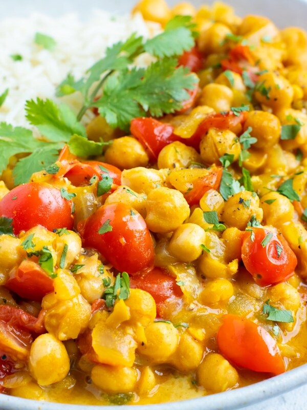 A close-up of vegetarian chickpea curry and tomatoes with basmati rice.