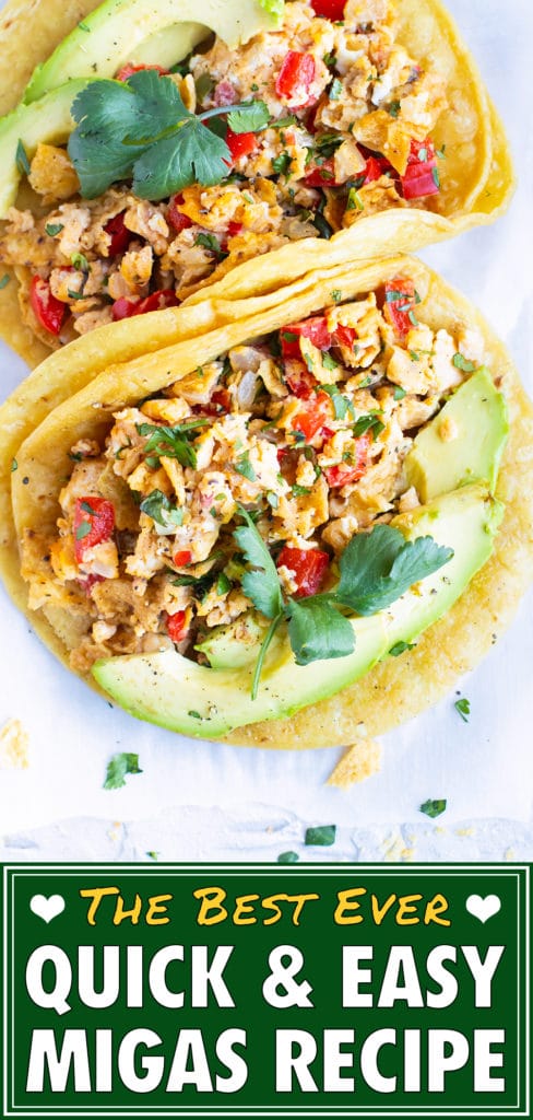 Two corn tortillas full of a healthy migas recipe with cilantro and avocado as garnished.