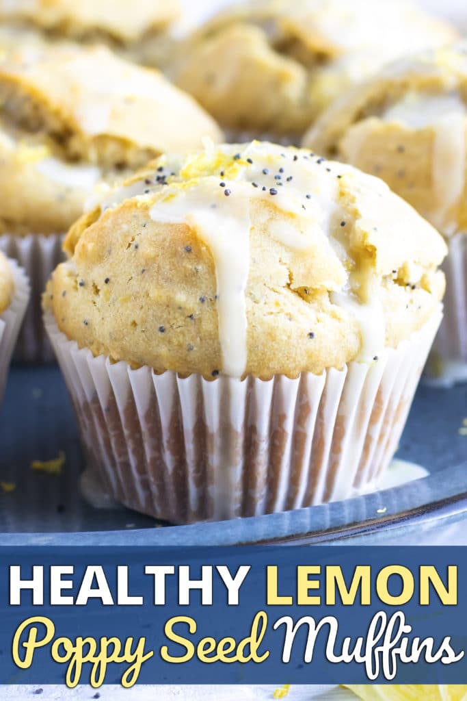 A tray full of healthy, gluten-free lemon muffins with a powdered sugar glaze and poppy seeds.