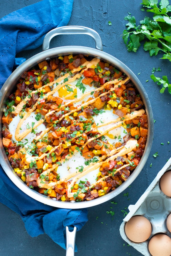 Learn how to make sweet potato hash with eggs in a stainless steel skillet.