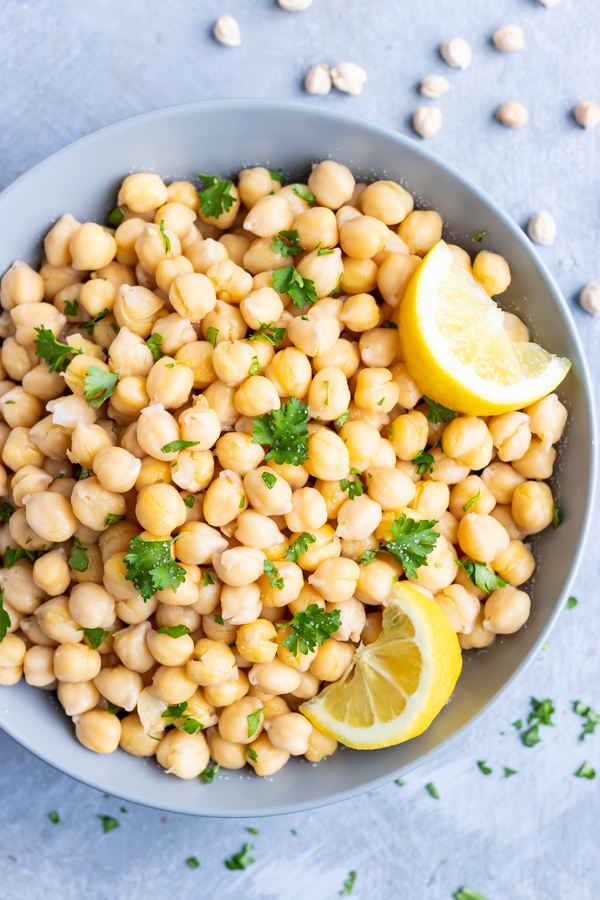A bowl full of cooked garbanzo beans that are full of fiber, protein, and calories.
