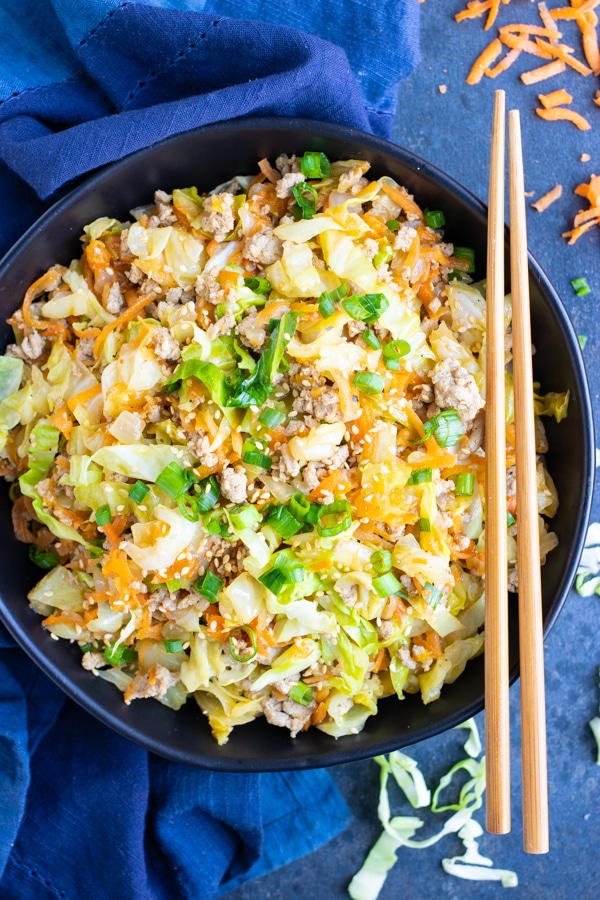 Keto and Paleo egg roll in a bowl dinner recipe with chopsticks and a blue napkin.
