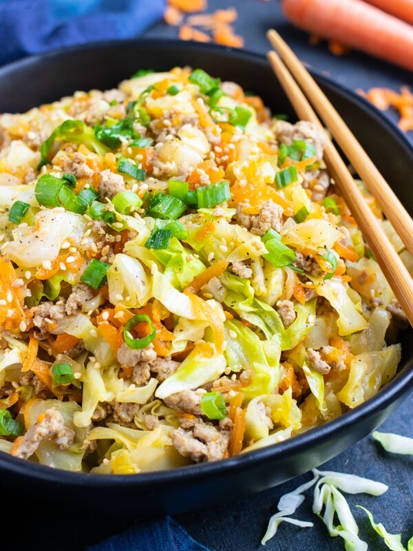 An easy and healthy keto dinner egg roll in a bowl recipe that is made of ground turkey or beef, cabbage, carrots, and Asian flavors.