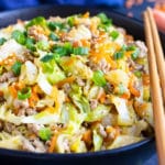 Keto and low-carb egg roll in a bowl recipe with chopsticks and a blue napkin.
