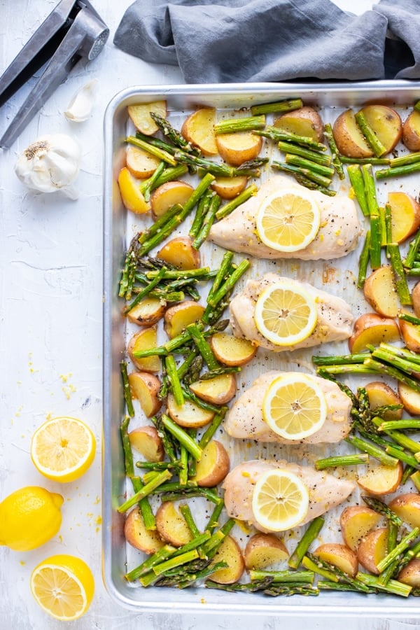 Lemon Garlic Chicken and Asparagus with Red Potatoes on a sheet pan.