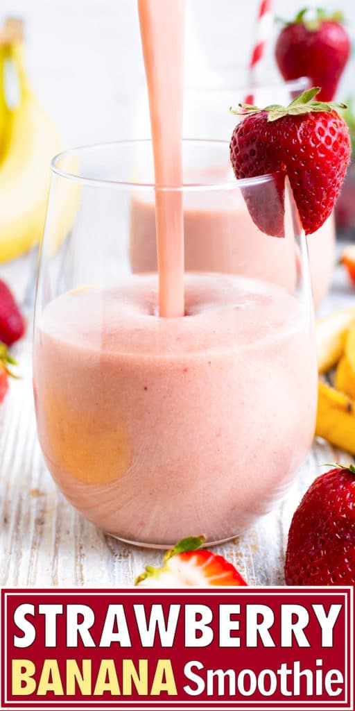 Strawberry banana smoothie being poured into a glass with strawberries and bananas around it.