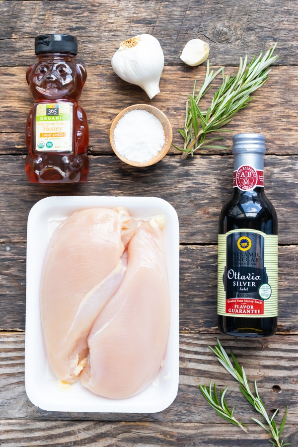 Chicken breasts, honey, balsamic vinegar, garlic, and rosemary as the ingredients for a balsamic glazed chicken breast recipe.