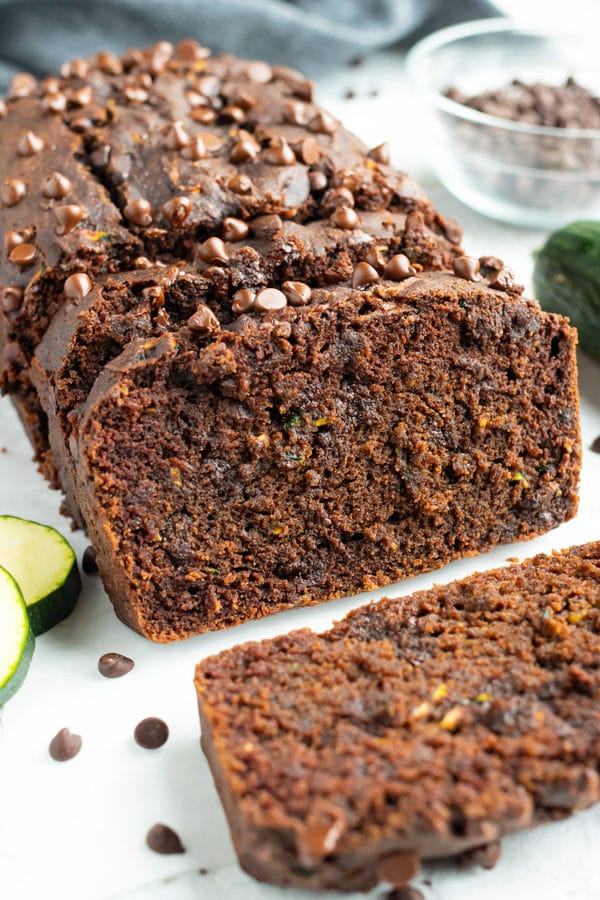 Chocolate Zucchini bread recipe with chocolate chips on a white table.