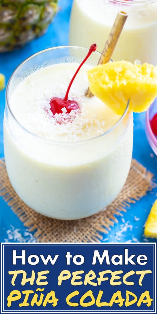 A frozen piña colada recipe in a clear glass with a pineapple wedge and a maraschino cherry.